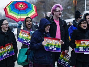 Protesters demonstrate against Bill 10, which mandates that schools provide a gay-straight alliance if a student makes a request, during the Alberta legislature's Christmas light-up event in Edmonton, Alta., on Thursday, Dec. 4, 2014.
