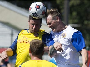 (left to right) Scott Reid and Ryan Walker 24 head a ball as Andrew Rigby (#17) looks on during the Woodall Cup at Clarke Stadium, in Edmonton Alta. on Sunday July 26, 2015. The charity soccer game pitted a team of British ex-pats against Edmonton Police Service officers. The third edition of the game is Friday (3:30 p.m.) at Clarke Stadium.