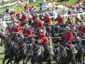 A troop of 32 horses and riders make up the RCMP Musical Ride performing in front of a few thousand people at Amberlea Meadows south of Edmonton on August 6, 2017.