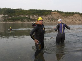 The Element triathlon club takes off on one of its regular swims in the North Saskatchewan River on Wednesday, Aug. 16, 2017, in Edmonton.