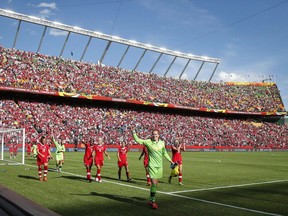 Canada goalie Erin McLeod, centre, waves as she leads her teammates around the stadium after defeating China during FIFA Women's World Cup soccer action at Commonwealth Stadium in Edmonton, Alta., on June 6, 2015. A preliminary list of 44 potential host cities, including seven in Canada, have been released by the joint North American bid for the 2026 World Cup.