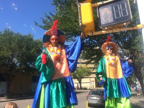 A stilt walker blows bubbles at passersby during the Experience Jasper Avenue design demonstration on Aug. 26, 2017.