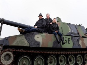 Sean Rayner, the fourth generation company president of the VETS Group, left, his father David Rayner, the third generation president. and daughter and marketer Erin Rayner, a member of the fourth generation in the company, on a M109 Howitzer at Hole 15 of the Edmonton Garrison Memorial Golf and Curling Club. The Thursday, Aug. 10, 2017 fundraiser supported Valour House, Little Warriors and Habitat for Humanity.