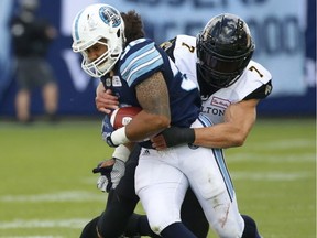 Hamilton Tiger Cats John Chick DE (7)  ties up Toronto Argonauts Declan Cross FB (38) during the fourth quarter in Toronto, on June 25, 2017.