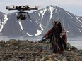 A drome films a shaman character on the Russian Bering Strait in production of The Great Human Odyssey.