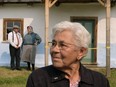 Genia Saik, 88, stands in front of the house where she once lived. The house was moved from the Innisfree, Alta., area to the new Galician Settlers Farmstead at the Ukrainian Cultural Heritage Village, which was officially opened on Sunday Aug. 13, 2017.