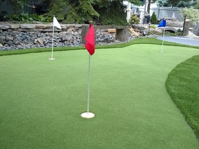 Rob and Glenda Hodge updated the landscaping in their southwest Edmonton backyard to include a three-hole putting green, complemented by a stream and basalt stone bench.