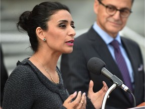 New board member Manjit Minhas (of Dragons Den) speaks as Minister of Finance Joe Ceci listens after he provided an update on appointments to provincial agencies, boards and commissions at the Alberta Legislature in Edmonton, September 26, 2017.