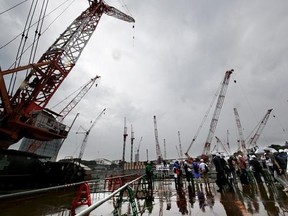 Members of the media review the construction of the new national stadium in Tokyo, Tuesday, Sept. 12, 2017. Tokyo&#039;s main Olympic stadium is starting to take shape as structures of what will become spectator stands are being installed after 10 months of underground foundation work. (AP Photo/Shizuo Kambayashi)