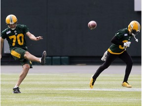 Kicker Hugh O'Neill and Garry Peters take part in an Edmonton Eskimos' team practice at Commonwealth Stadium, Monday Aug. 21, 2017.