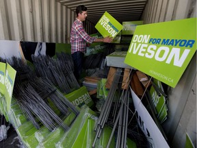 File: Mayor Don Iveson unpacks a storage container filled with election signs as he prepares for the upcoming election, in Edmonton Monday Sept. 4, 2017.