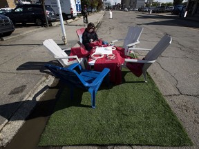 Becky Thera works at a collaborative embroidery performance set up in a parking space during PARK(ing) Day in Edmonton Friday Sept. 15, 2017. PARK(ing) Day transforms parking stalls into temporary parks, creative installations, interactive projects, and workshop spaces along Okisikow Way (101A Avenue) near 97 Street.