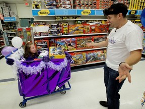 Sadie Martin, 10, and her father Mark Martin react after finishing their three-minute shopping spree through Toys "R" Us, 3940 Gateway Blvd., in Edmonton on Tuesday, Sept. 26, 2017.