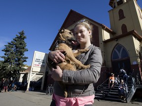 Rebecca Hewett holds her dog Loki while visiting a vet at the Mustard Seed Church, 10635 96 St., in Edmonton Tuesday Sept. 26, 2017.