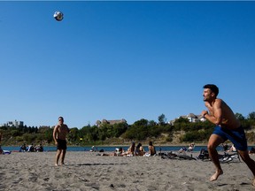 Colten Thurrott, left, and Adam Nelubowich enjoy a hot summer day on accidental beach in Edmonton on Tuesday, Aug. 29, 2017.