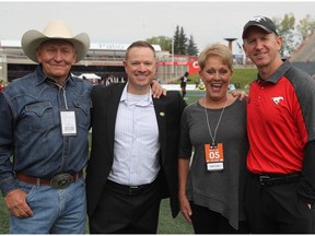 Calgary Stampeders head coach Dave Dickenson, right, and Edmonton Eskimos GM Brock Sunderland meet up with legendary Montana high school football coach Jack Johnson, left, and his wife, Rosann, ahead of the 2017 Labour Day Classic at McMahon Stadium on Monday, Sept. 4, 2017.