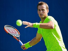 Vasek Pospisil of Canada returns a shot to Fernando Verdasco of Spain during their first round Men's Singles match  on Day Three of the 2017 US Open at New York's USTA Billie Jean King National Tennis Center on Aug. 30, 2017.