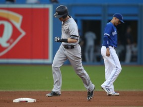 Todd Frazier of the New York Yankees circles the bases after hitting a solo home run in the eighth inning against the Blue Jays during their game Saturday at Rogers Centre in Toronto.