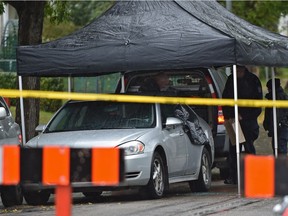 Police closed off 37 Street to traffic as they investigated the scene where a body was found in this car in Edmonton on Sept. 19, 2017.