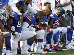 Buffalo Bills players kneel during the national anthem prior to an NFL game against the Denver Broncos on Sept. 24, 2017, in Orchard Park, N.Y.
