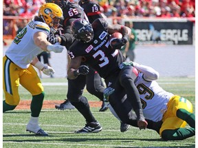 Calgary Stampeders running back Jerome Messam runs the all against the Edmonton Eskimos during the first half of the Labour Day Classic at McMahon Stadium, Monday September 4, 2017.