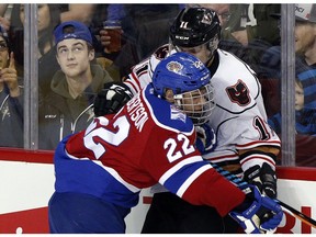 Oilkings rookie Matthew Robertson knocks Hitmen Beck Malenstyn off the puck as the Calgary Hitmen took on the Edmonton Oil Kings at the Scotiabank Saddledome in Calgary, Alta., on February 17, 2017.