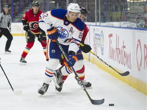 Edmonton Oilers prospect defenceman Caleb Jones picks up the loose puck during the Young Stars Classic against the Calgary Flames rookies at the South Okanagan Events Centre in Penticton, B.C., on Sept. 8, 2017.