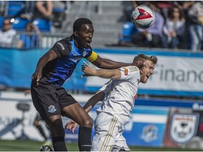 Tomi Ameobi of the FC Edmonton, tries to head the ball towards the net and past Connor Tobin of North Carolina FC at Clark Stadium on September 10, 2017.