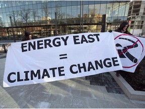 Members of Stop Energy East Halifax protest outside the library in Halifax on Monday, Jan. 26, 2015. In a decision cheered by environmentalists but considered a setback by the oil industry, Canada's national energy regulator says it will allow wider discussion of greenhouse gas emission issues in upcoming hearings for the Energy East Pipeline. File photo.