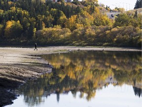 People walk along the North Saskatchewan River on what has become known as the accidental beach on Wednesday Sept. 27, 2017 in Edmonton.