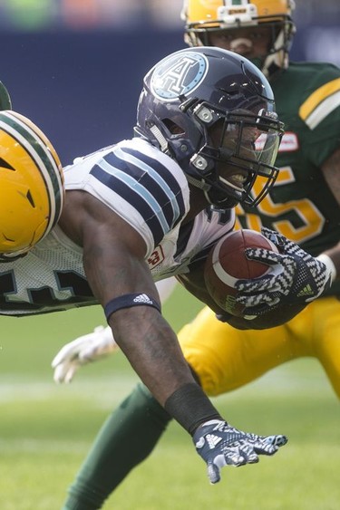 Toronto Argonauts running back James Wilder Jr. (right) is tackled by Edmonton Eskimos linebacker Alex Hoffman-Ellis during the first-half of CFL football action in Toronto on Saturday, September 16, 2017.