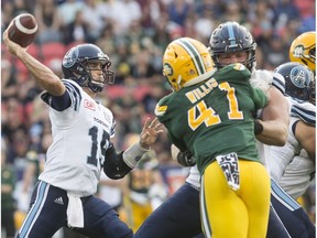 Toronto Argonauts quarterback Ricky Ray, left, looks to make a pass during second half CFL football action against the Edmonton Eskimos in Toronto on Saturday, September 16, 2017.