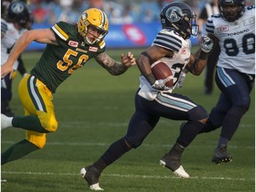 Toronto Argonauts running back Martese Jackson, centre, runs the ball from his own goal line as he returns a missed field goal to score a touch down during second half CFL football action against the Edmonton Eskimos in Toronto on Saturday, September 16, 2017.