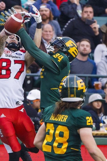Calgary Stampeders Rory Kohlert (87) fights Edmonton Eskimos Garry Peters (34) for the catch during first half CFL action in Edmonton on Sept. 9, 2017.