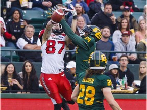 Calgary Stampeders Rory Kohlert (87) fights Edmonton Eskimos Garry Peters (34) for the catch during first half CFL action in Edmonton on Sept. 9, 2017.