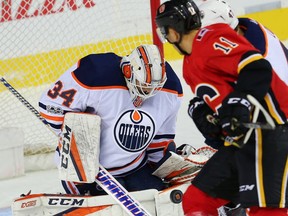 Edmonton Oilers goalie Nick Ellis with a save against the Calgary Flames during NHL pre-season hockey at the Scotiabank Saddledome in Calgary on Monday, September 18, 2017.