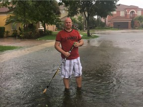 Attila Hertelendy, who was born and raised in Edmonton before becoming a professor in business at Florida International University and an adjunct research professor at Georgetown University teaching emergency management, stands outside his home in West Palm Beach, Florida, on Sunday, Sept. 10, 2017, as hurricane Irma sweeps across Florida.