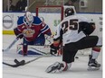 Travis Child of the Edmonton Oil Kings, blocks a shot from Cael Zimmerman of the Calgary Hitmen at the Community Rink in Rogers Place in Edmonton on September 10, 2017.