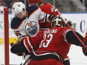 Carolina Hurricanes goalie Scott Darling (33) makes the save as Edmonton Oilers forward Kailer Yamamoto looks for the rebound during NHL pre-season action on Sept. 25, 2017, at Rogers Place in Edmonton.