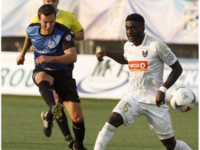 Edmonton's Ben Fisk (9) shoots past North Carolina's Christian Ibeagha (15) during the second half of a NASL soccer game between FC Edmonton and North Carolina FC at Clarke Stadium in Edmonton on Friday, July 7, 2017.  FC Edmonton are in Carolina on Saturday.