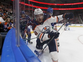 Edmonton's Patrick Russell (52) battles Vancouver's Jalen Chatfield (63) during a preseason NHL game between the Edmonton Oilers and the Vancouver Canucks at Rogers Place in Edmonton, Alberta on Friday, September 22, 2017. Ian Kucerak / Postmedia Photos for stories running Saturday, Sept. 23 edition.