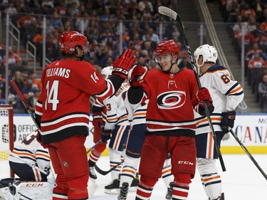 Carolina Hurricanes forward Janne Kuokkanen, right, celebrates his goal on Edmonton Oilers goalie Cam Talbot with teammate Justin Williams during NHL pre-season action on Sept. 25, 2017, at Rogers Place in Edmonton.