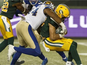 Edmonton's Brandon Zylstra (83) is tackled by Winnipeg's Jackson Jeffcoat (94) during the first half of a CFL football game between the Edmonton Eskimos and the Winnipeg Blue Bombers at Commonwealth Stadium in Edmonton, Alberta on Saturday, September 30, 2017.