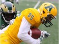 University of Alberta Golden Bears receiver Nathan Rowe, right is tackled by University of Regina Rams defensive back Polis Koko at New Mosaic Stadium in Regina, Sask., on Sept. 16, 2017.