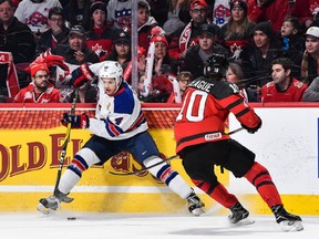 Caleb Jones #4 of Team United States skates the puck against Kale Clague #10 of Team Canada during the 2017 IIHF World Junior Championship gold medal game at the Bell Centre on January 5, 2017 in Montreal, Quebec, Canada.