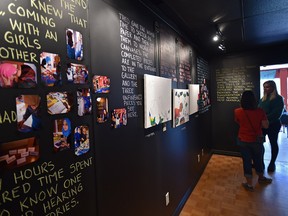 People viewing art from four district high school students and their mothers who worked with Artist Theo Harasymiw to create numerous pieces of artwork to tell their stories about coming to Canada from Syria being shown at the Dandi-Lines Art Gallery called My Journey Thus Far, in Edmonton, September 28, 2017. Ed Kaiser/Postmedia (Edmonton Journal story)