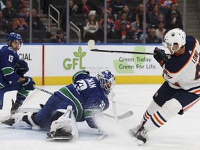 Edmonton's Keegan Lowe (47) scores on Vancouver's goaltender Richard Bachman (32) which was later ruled goaltender interference during a preseason NHL game between the Edmonton Oilers and the Vancouver Canucks at Rogers Place in Edmonton on Friday, September 22, 2017.