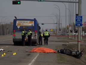 Edmonton Police officers investigate the scene of a motorcycle fatality on 97 street near 153 Avenue on Thursday April 20, 2017 in Edmonton.  The motorcyclist ran into the back of the bus.