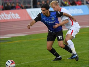 FC Edmonton midfielder Mauro Eustaquio battles for the ball with San Francisco Deltas midfielder Kyle Bekker in North American Soccer League play in San Francisco on Saturday, Sept. 23, 2017.