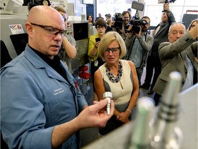 Alberta Premier Rachel Notley gets a demonstration from NAIT machinist program instructor Ryan Reeves on Wednesday September 6, 2017.